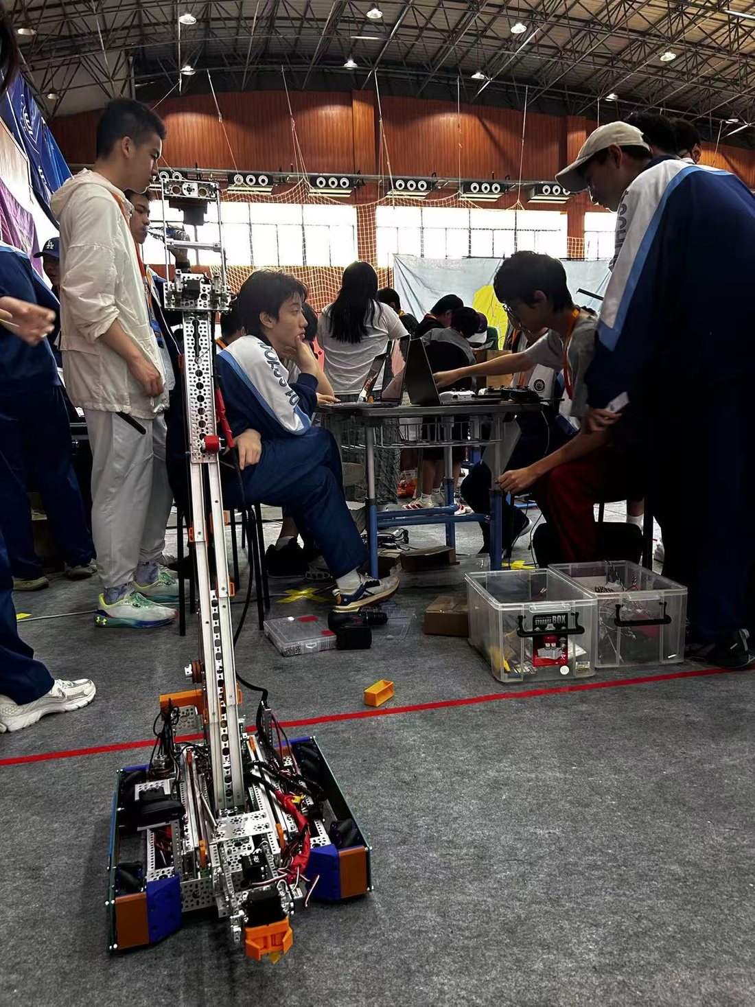 Team members working on competition robot 28660 in the pit area during the build.