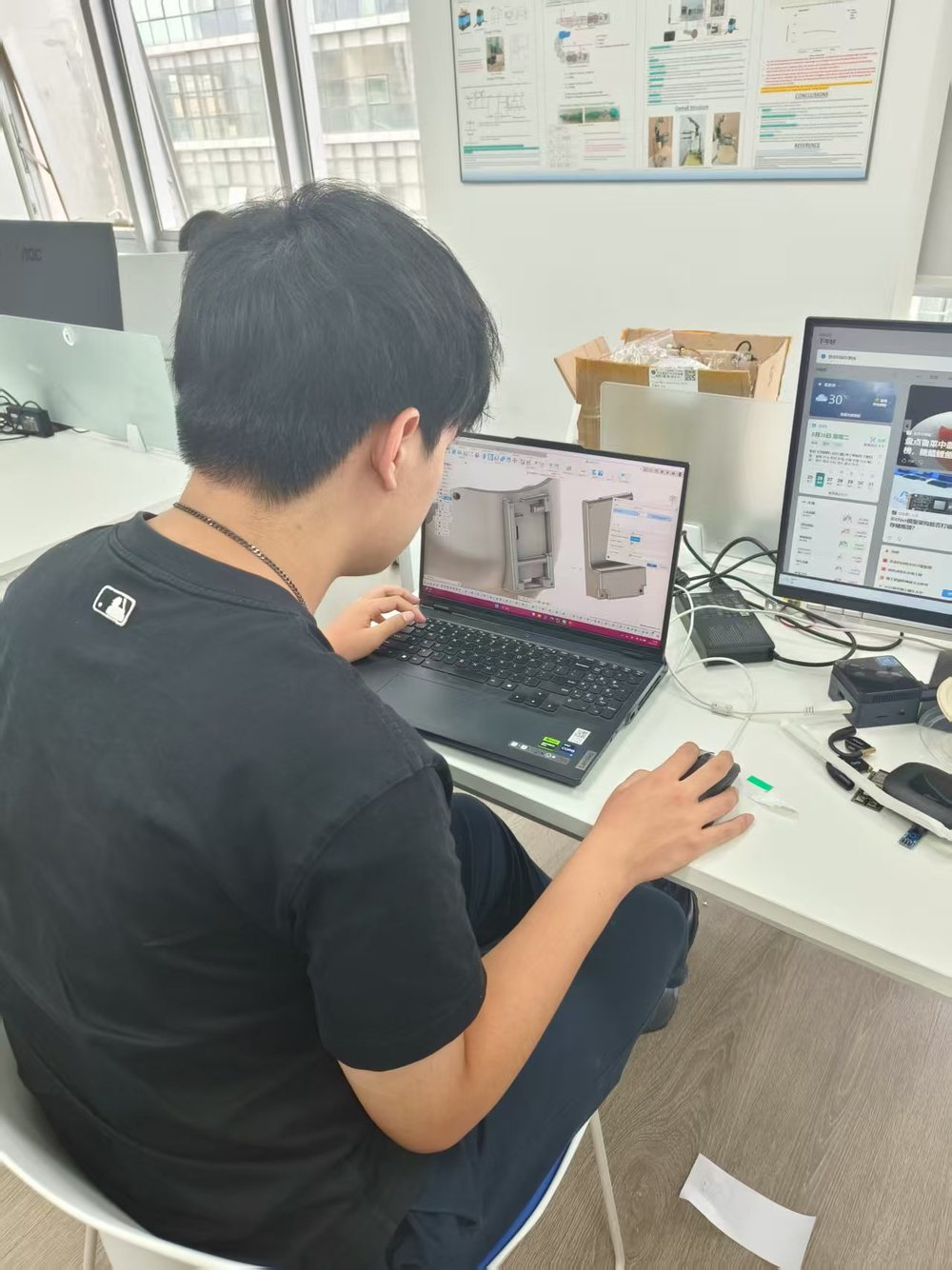 Modelling the glove enclosure on a laptop, with the printed shell and components on the desk.